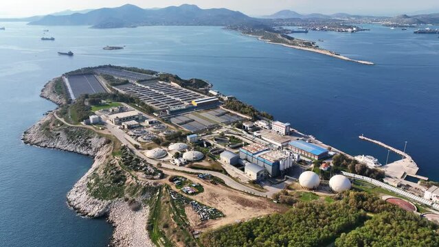 Aerial drone video of small industrial island of Psitaleia the largest sewage treatment plant in Europe, Saronic gulf, Peiraeus, Attica, Greece