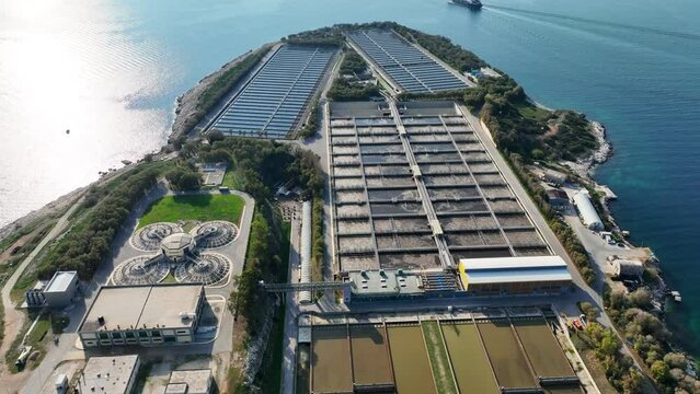 Aerial drone video of small industrial island of Psitaleia the largest sewage treatment plant in Europe, Saronic gulf, Peiraeus, Attica, Greece