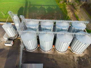 Drone flight over a large agro-industrial complex and barrels of grain. silos at the agro...