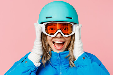 Close up snowboarder fun woman wear blue suit goggles mask hat ski padded jacket hold helmet look...