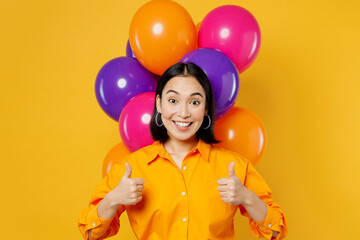 Fototapeta na wymiar Happy fun surprised shocked excited young woman wears casual clothes celebrating near balloons point index finger on herself isolated on plain yellow background. Birthday 8 14 holiday party concept.