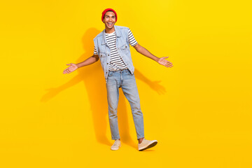 Fototapeta na wymiar Full length photo of impressed funky man wear jeans outfit rising arms crossed isolated yellow color background