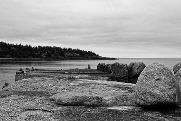 The old dilapidated pier of Sandy Cove, Nova Scotia, in black and white.
