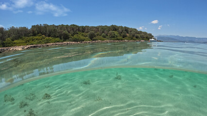 Underwater split photo of famous turquoise beach of Monolia in small complex islands of Lihadonisia often calles as Seychelles of Greece, North Evia