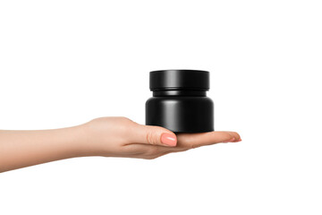 A black jar with a beautiful glare in a female hand with a manicure, on a white background.