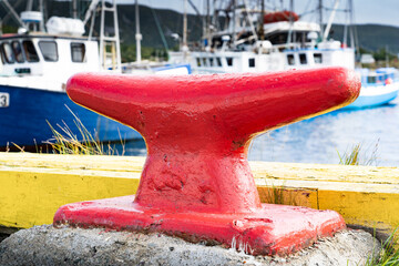 Large boat cleat used for securing fishing vessels at a seaside port in Heart's Content Newfoundland Canada.