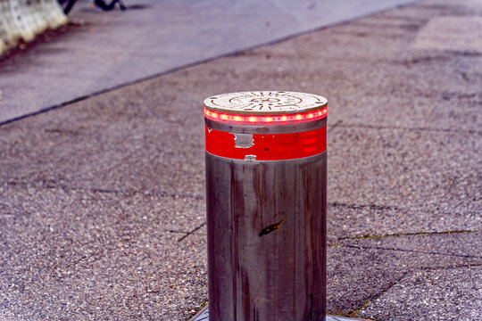 Metal hydraulic metal poller with red led warning light at City of Baden, Canton Aargau, on a cloudy autumn day. Photo taken November 13th, 2022, Baden, Switzerland.