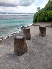 Naklejka premium bench on the beach with ocean background 