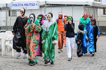 Group of people parading dressed in horror costumes at the carnival