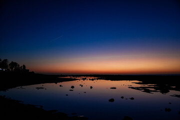Fototapeta na wymiar Sea and sun at sunset, orange sunset, blue sea night photo, stars and nature.