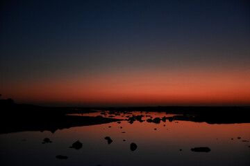 Sea and sun at sunset, orange sunset, blue sea night photo, stars and nature.