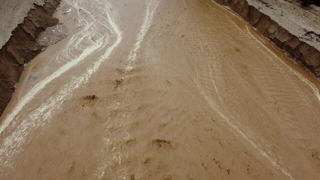 Flood Runoff Channel used to prevent Flooding with active Water flow from a Recent Storm in Yucaipa California, in the Wildwood Creek.