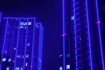 Modern tall buildings with apartments at night.