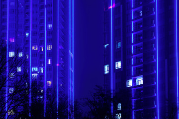 Modern tall buildings with apartments at night.