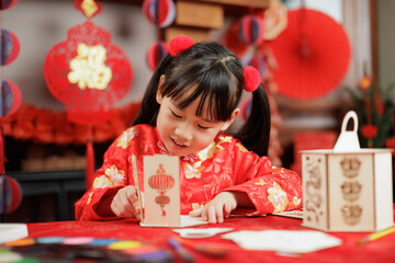 young girl with traditional dressing up celebrating Chinese new year against all kind of 