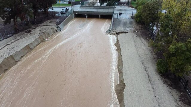 Flood Runoff Channel used to prevent Flooding with active Water flow from a Recent Storm in Yucaipa, California, in the Wildwood Creek