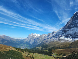Fototapeta premium Hiking track with snow mountain view with green meadow landscape mode