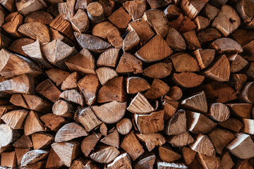 Chopped firewood is stacked in a big pile