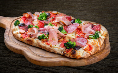 Pizza with salami, ham, vienna sausages, kalamata, olives, broccoli, pelati, pesto. Roman pizza rectangular on wood background