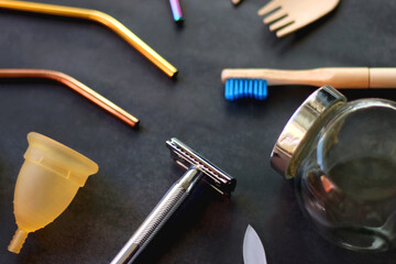 Various sustainable beauty products and kitchen utensils on dark background. Selective focus.