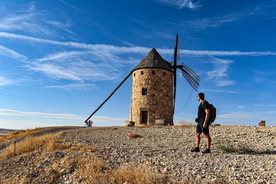 Hombre turista observando molino de viento tradicional