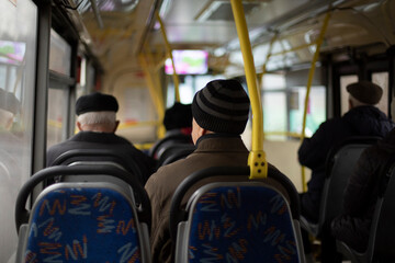 Fototapeta na wymiar People on bus. Seating on public transport. Seats in interior of bus. Passengers in transport.
