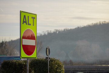 Wrong or one way signal on italian motorway with writing alt or stop. High visibility color of one...