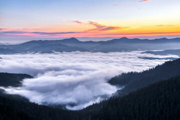 Panorama with sunrise. Landscape with high mountains. Morning fog. Natural scenery.