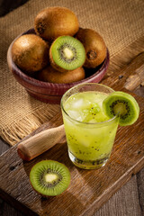 Brazilian Kiwi Caipirinha. Cachaça drink with kiwi, on wooden background.