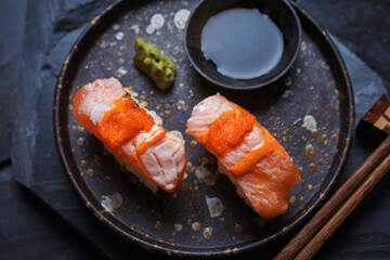 Burned salmon sushi with soy sauce and wasabi