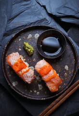 Burned salmon sushi with soy sauce and wasabi