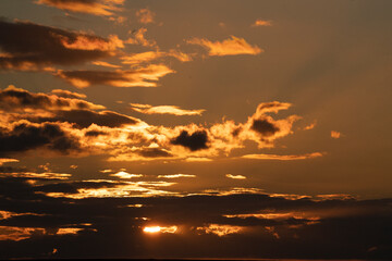 Fototapeta premium Orange sunset clouds with beautiful sun sky scape 