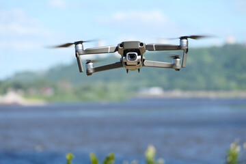 Gray quadcopter in flight. Photo-video aerial photography.