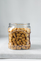 Nigerian Chin chin in a plastic jar, Fried chin-chin snack in a plastic jar, Nigerian party food and small chops