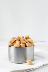 Nigerian Chin chin in a measuring cup, Fried chin-chin snack in a measuring cup, Nigerian party food and small chops