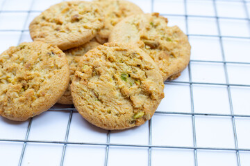 Pistachio and almond cookies on white background.