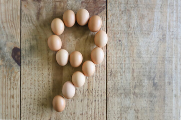 Number nine written with chicken eggs, arranged on a rustic pine wood base, ideal for use in Easter numerals.