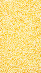 Couscous, dry wheat grain, food background texture, top view vertical banner
