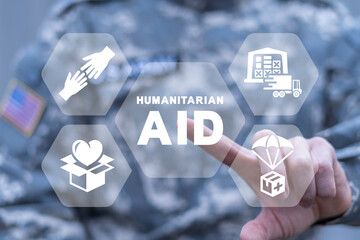 American soldier using virtual touchscreen presses of inscription: HUMANITARIAN AID. Concept of...