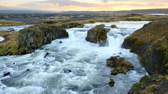 Autumn Waterfall in Iceland. Pure Turquoise Water in Mountain River. Popular Tourist Spot. Famous Travel Destination. Beautiful Nature, Unusual Landscape. Footage Shot in 8K Resolution 4320p