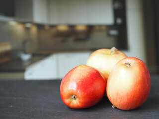 Ripe red apples on the table close-up.