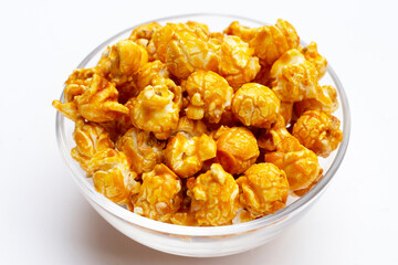 Honey caramel popcorn on white background.