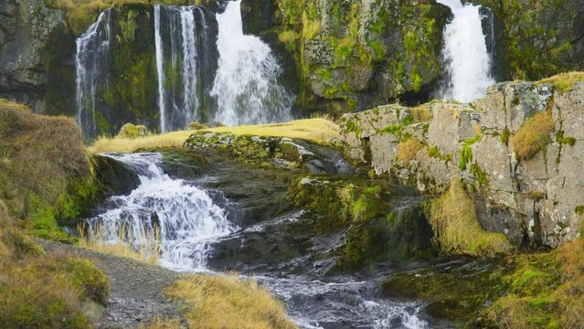 Autumn Waterfall in Iceland. Pure Turquoise Water in Mountain River. Popular Tourist Spot. Famous Travel Destination. Beautiful Nature, Unusual Landscape. Footage Shot in 8K Resolution 4320p