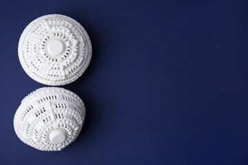 Laundry dryer balls on dark blue background, flat lay. Space for text