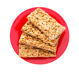 Plate with tasty peanut bars (kozinaki) isolated on white, top view