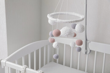 Modern baby mobile under crib in children's room