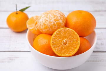 Fresh juicy tangerines on white wooden table, closeup