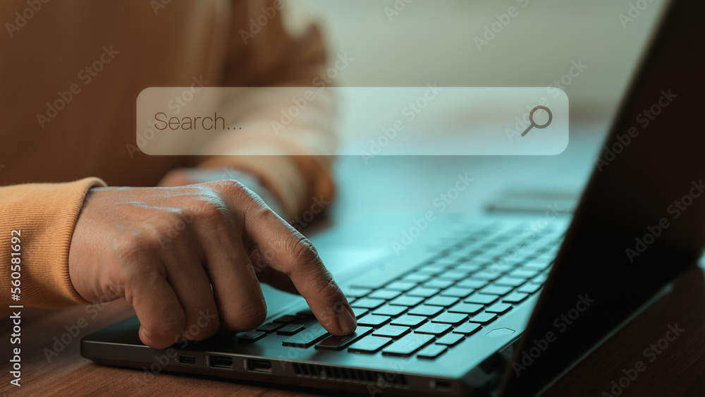 Poster Adult man hand working with computer laptop on desk in home. Searching Browsing Internet Data Information with blank search bar. Search Engine Optimization SEO Networking Concept.