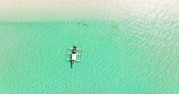 Boat on a tropical beach and turquoise water. Bantayan island, Philippines.