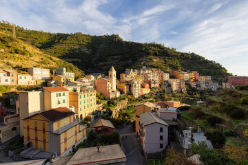 Fototapeta na wymiar Small touristic town on the coast and farmland, Manarola, Italy. Cinque Terre. Sunny Fall Season day.